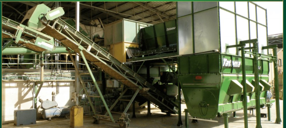 Bio-CNG silage processing line — conveyors and mixing hoppers inside the plant